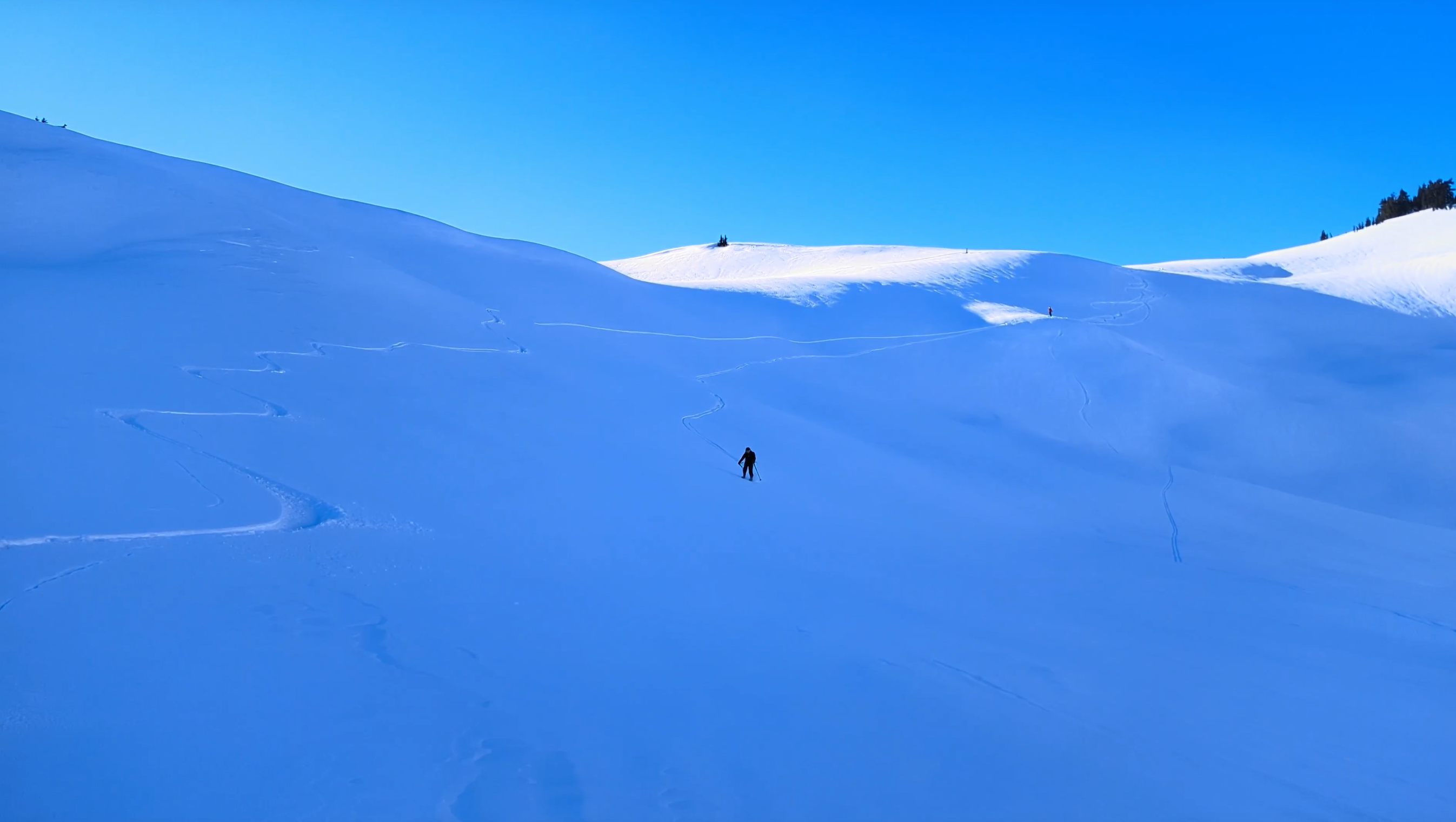 My ski tracks, and Anna skiing down
