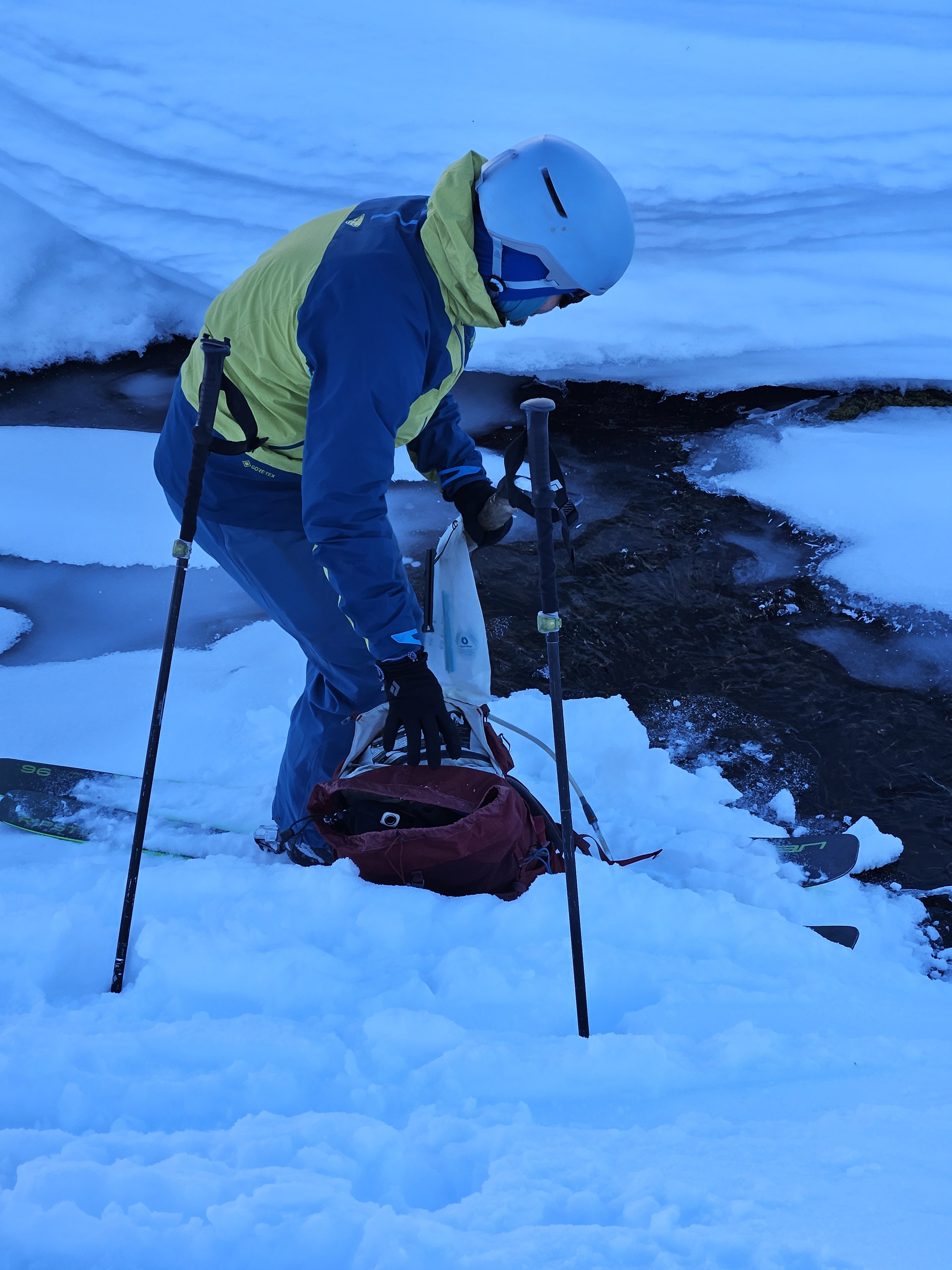 Me filling water from a half-frozen stream