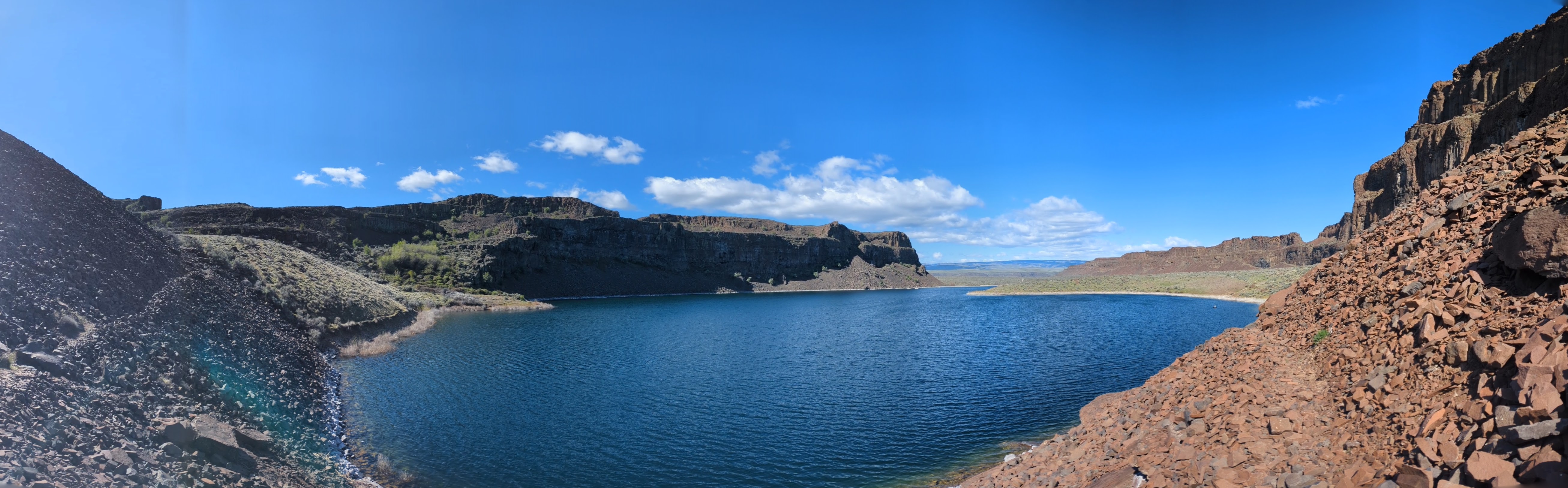 A much cleaner bluer lake, with loose rock all around the shore