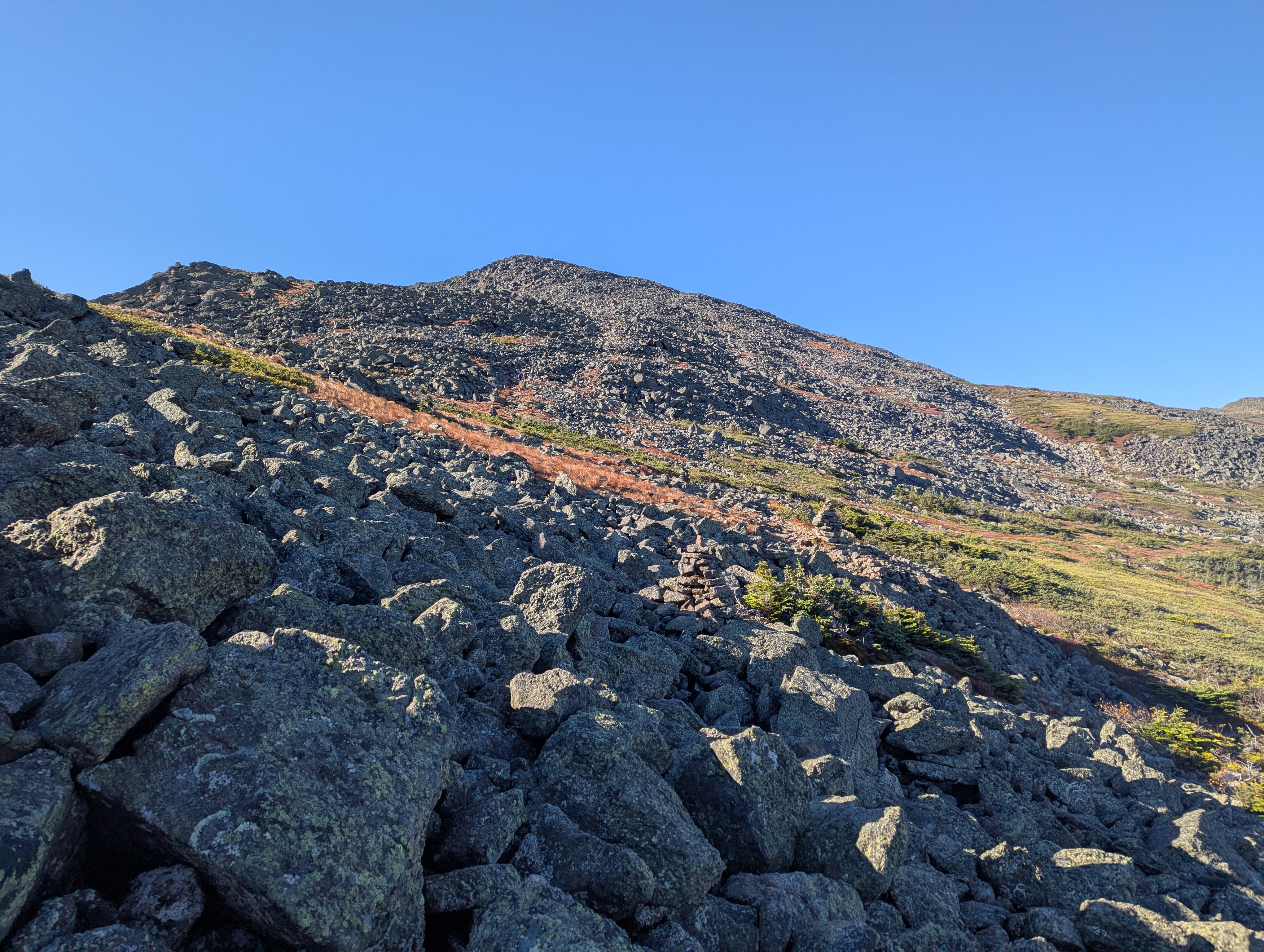 A rocky trail at my feet and a rocky summit up ahead