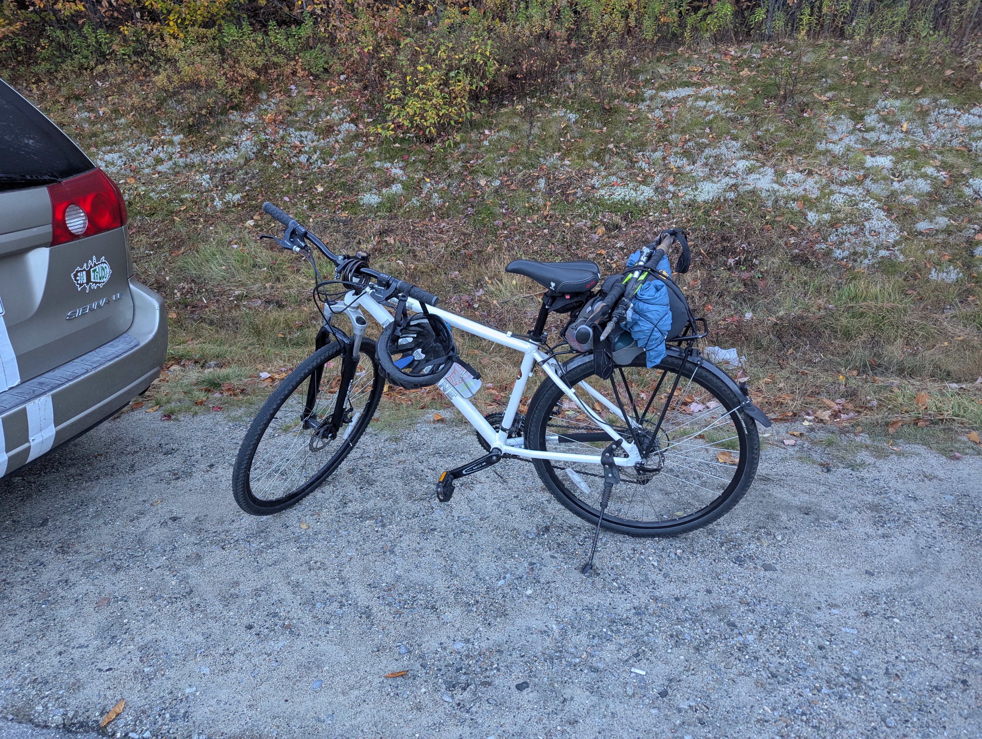My bicycle, with a running vest strapped to the cargo carrier and poles perpendicular across that.
