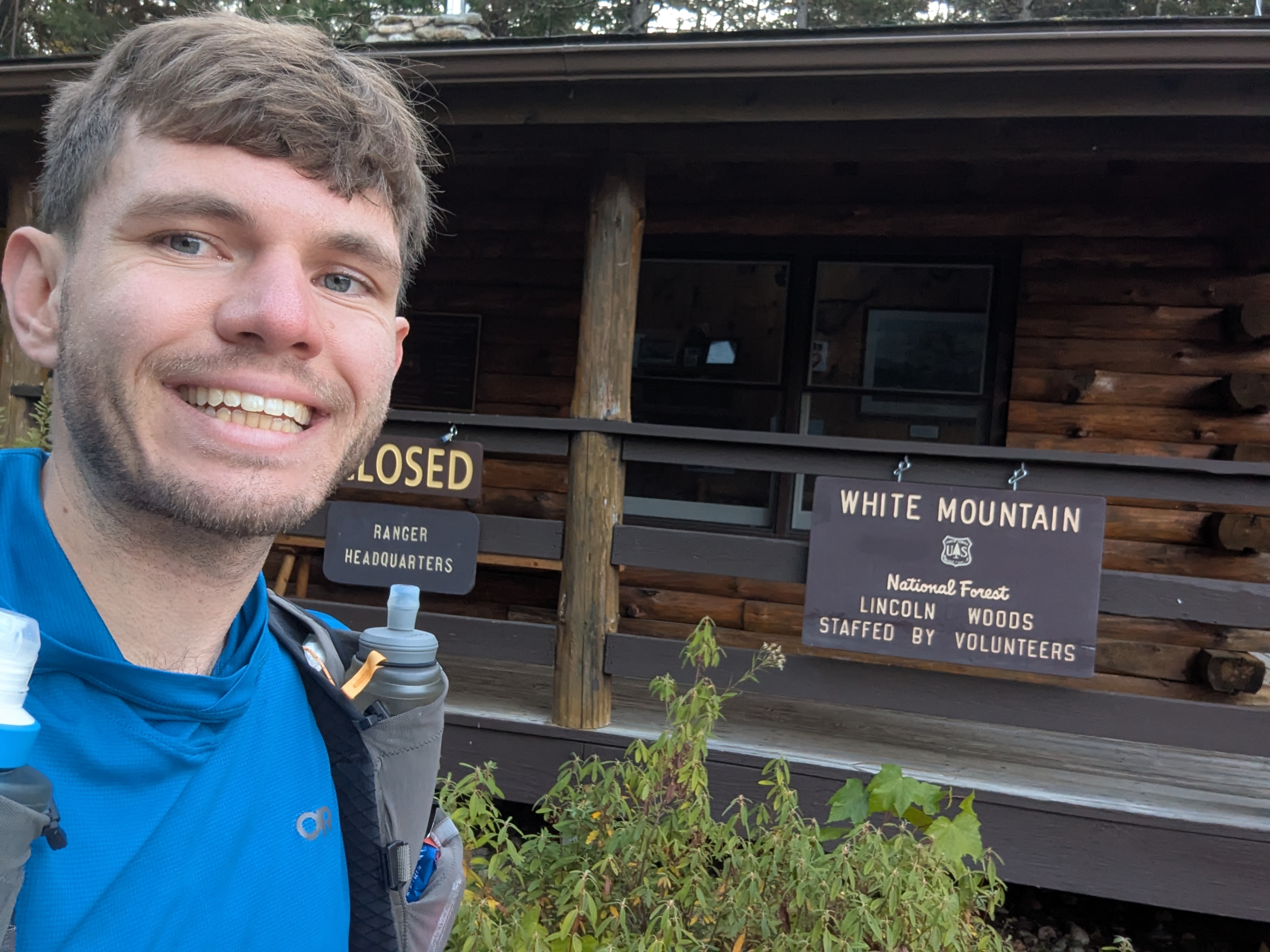 Me with a bad haircut grinning in front of the Lincoln Woods Ranger Station